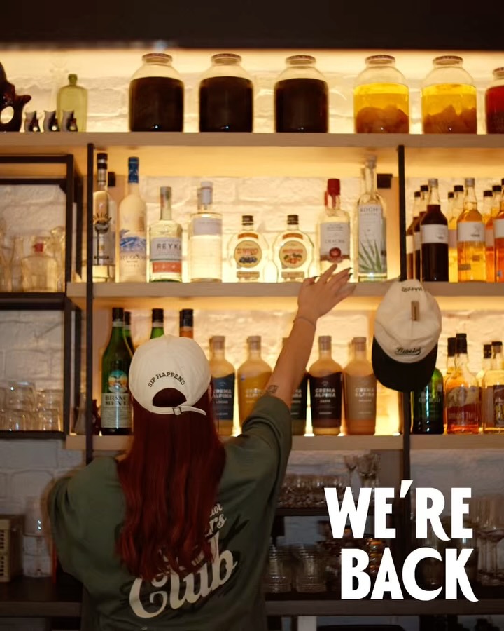 Shelves of house-made infusions behind the BIBELOT bar counter